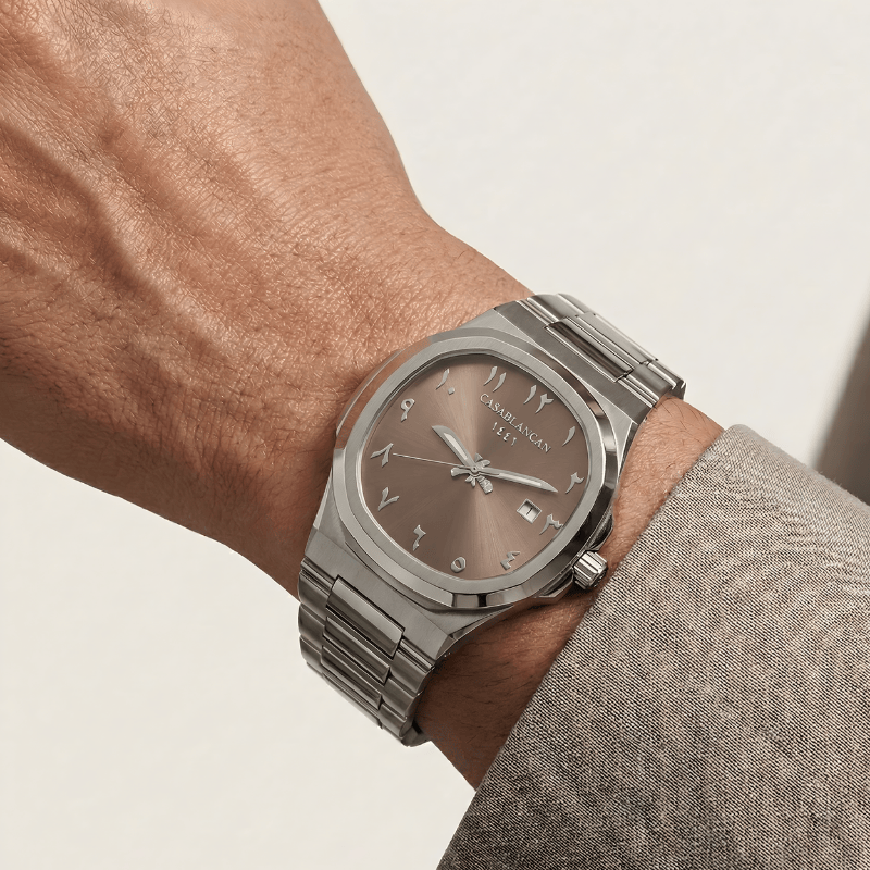 Casablancan Silver Arabic dial watch with a brown face on a wrist against a neutral background