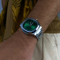Close-up of a Casablancan Al-Riyadh Heritage Arabic numeral green dial 43mm Watch, against a blurred background.