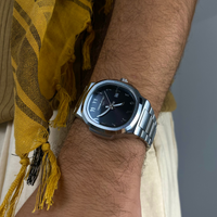 Casablancan Onyx Sentinel Arabic Dial 43mm on a wrist with a yellow scarf in the background close up sideshot