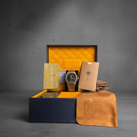 Watch in a decorative box with a brown leather pouch on a gray background