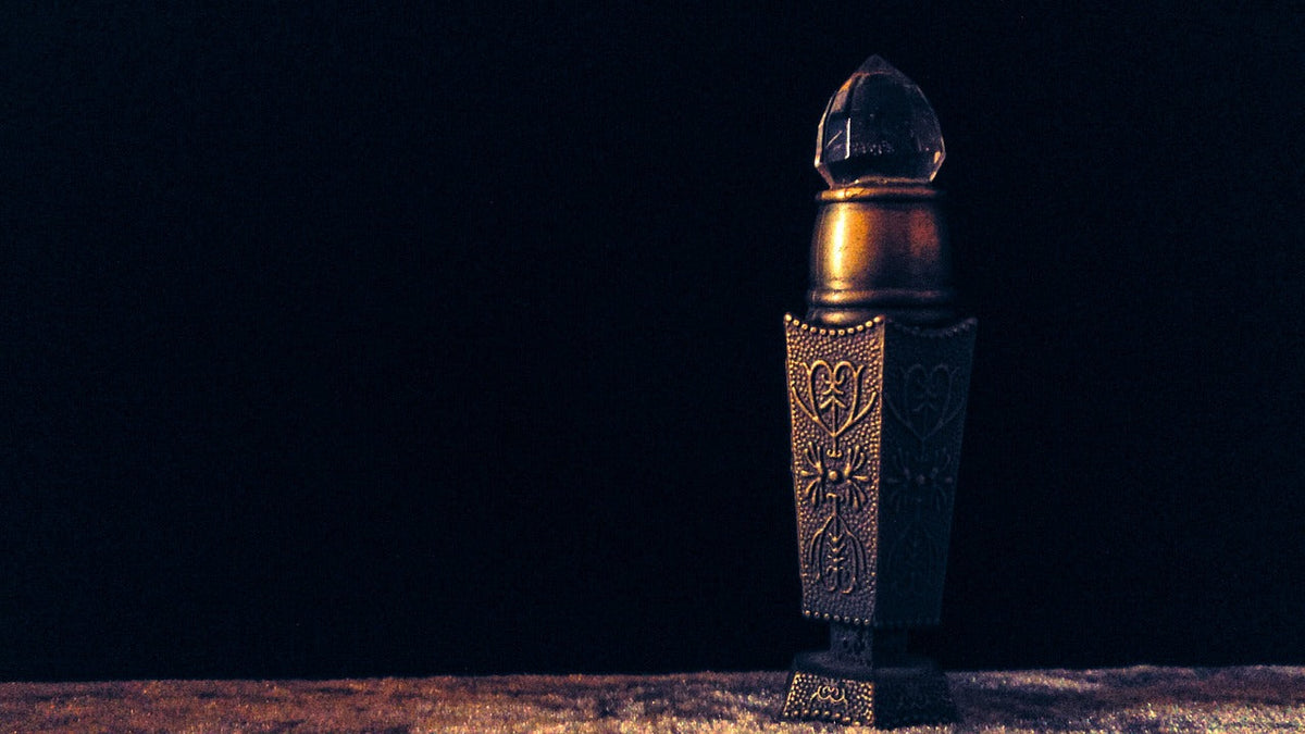 Dark glass vials containing traditional black attar perfume oil