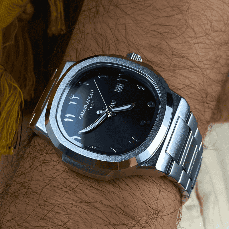 Silver Black arabic dial watch with black face on a wrist