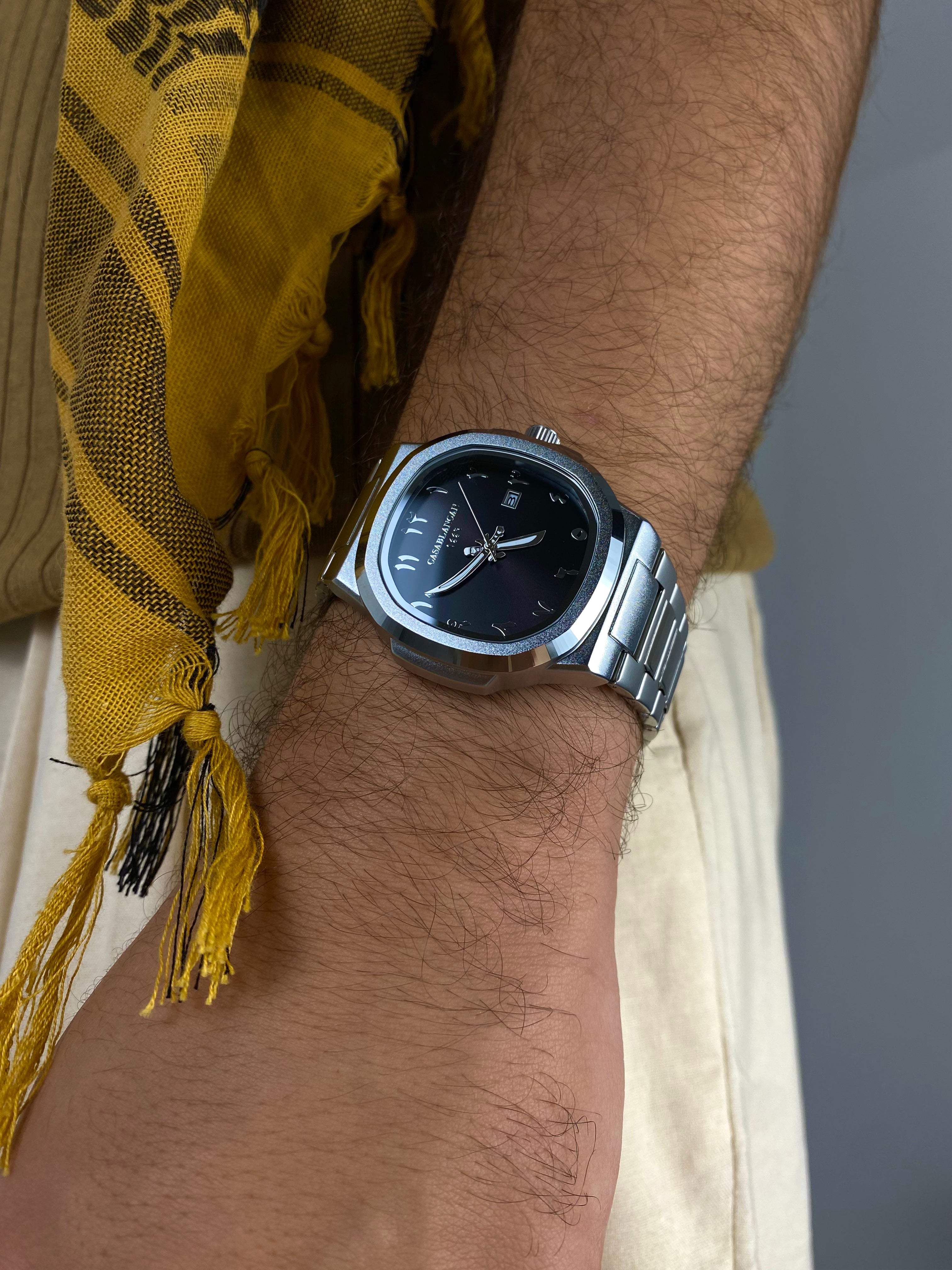 Casablancan Onyx Sentinel Arabic Dial 43mm on a wrist with a yellow scarf in the background close up sideshot