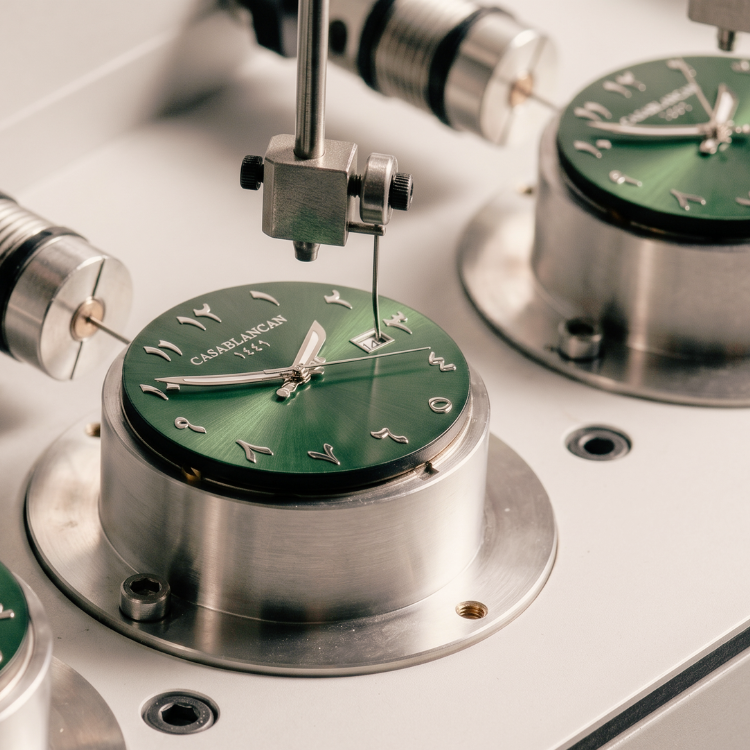 Close-up of a Casablancan Arabic dial watch mechanism with green face and metallic casing.