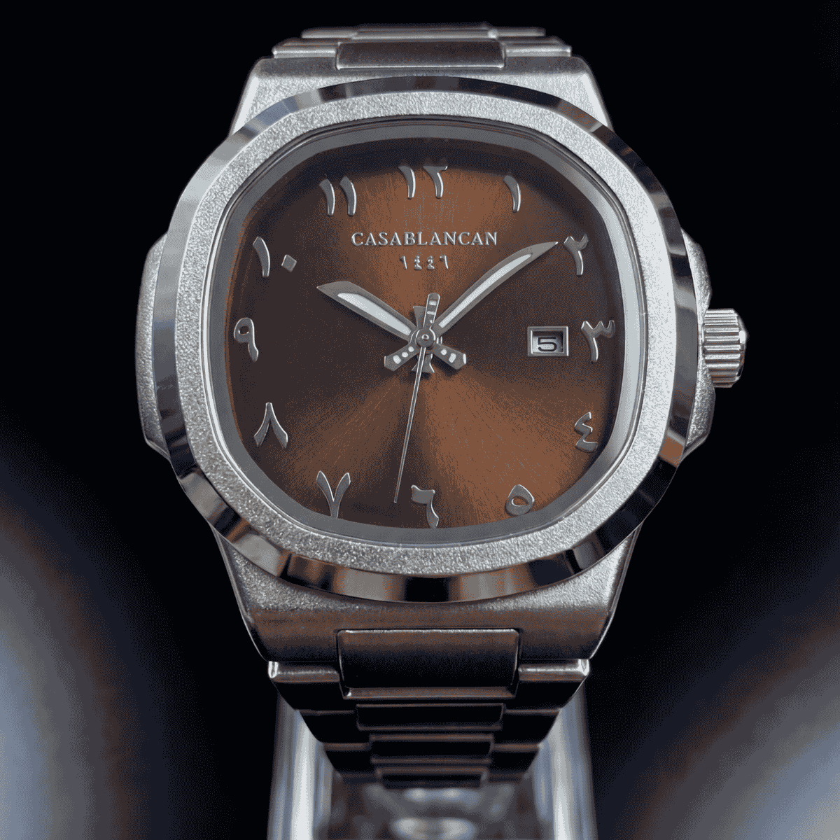 Casablancan Brown arabic dial Silver watch with a brown face on a black background front view 