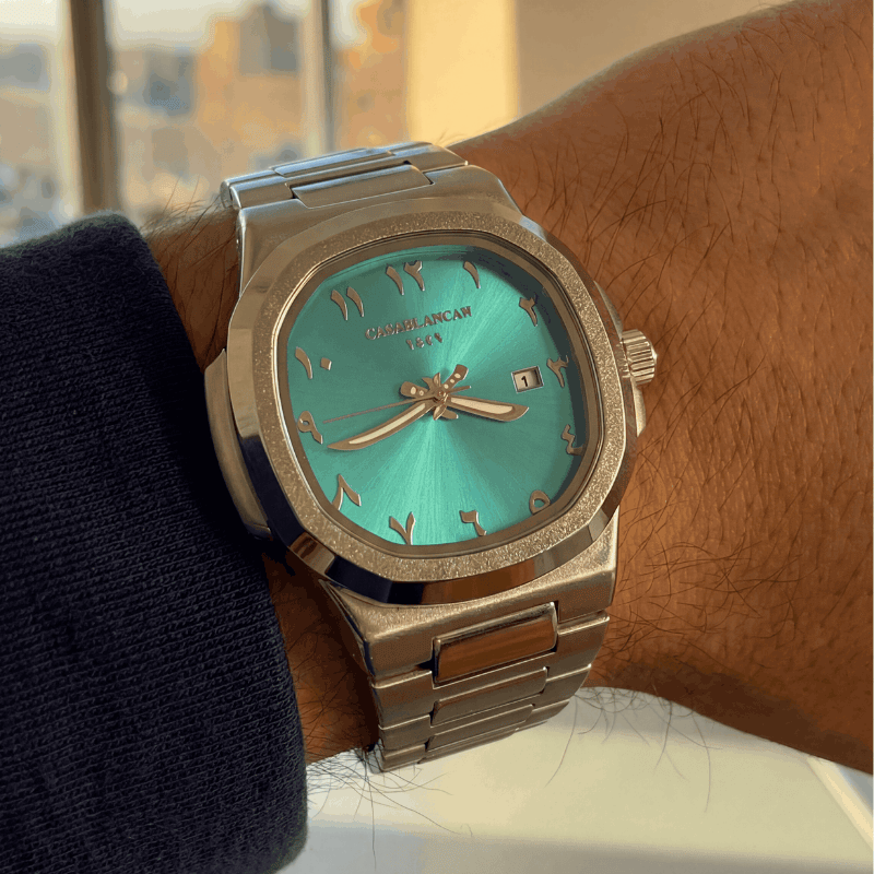 Casablancan Turquoise Arabic Dial watch with silver case on a wrist, blurred cityscape in the background custumer review