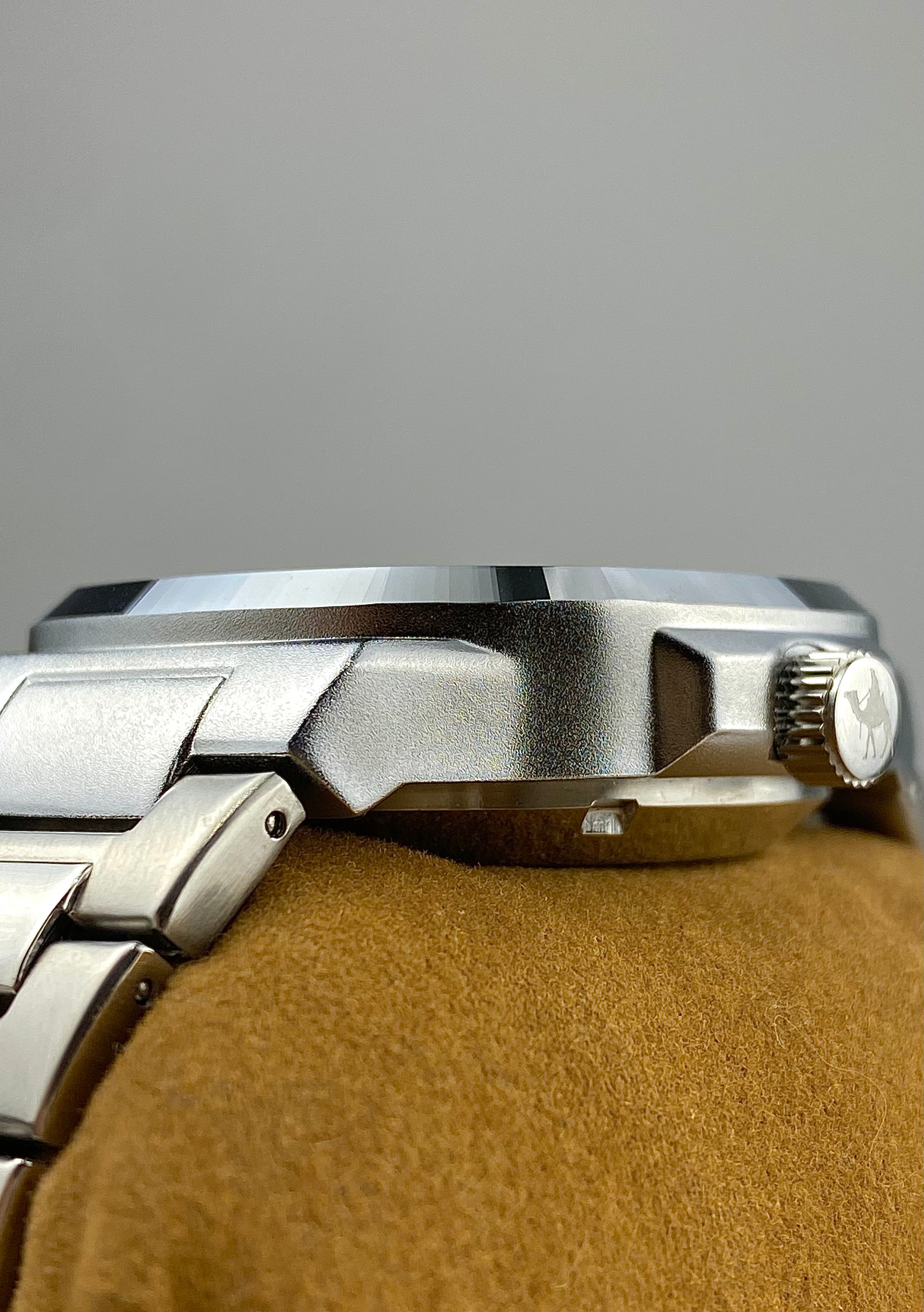 Close-up side shot of a Casablancan Arabic numerals watch on a brown leather strap against a gray background