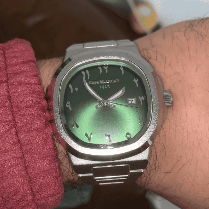Silver arabic dial. watch with a green face on a wrist, brand 'CasaBlancan' visible custumer review 