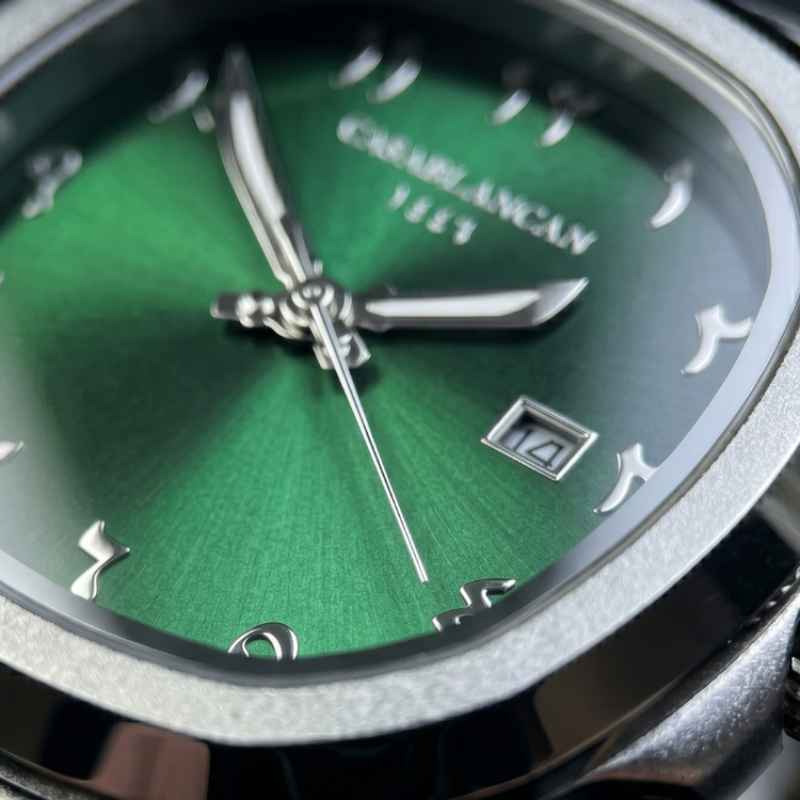 Close-up of a Casablanca 1113 watch dial with a vibrant green sunburst finish, silver-tone hands and markers, and a date window.
