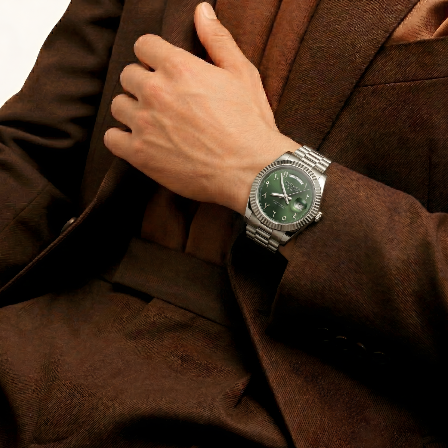 Hand wearing a watch with a unreleased casablancan Arabic dial green watch on a brown suit background