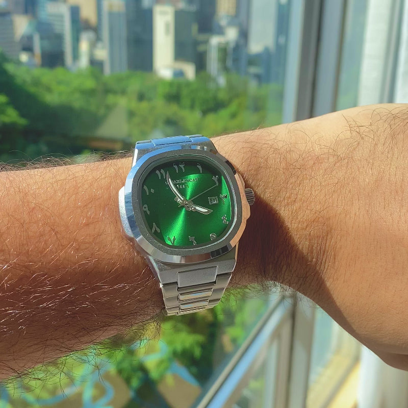 Green watch on a wrist with a cityscape background
