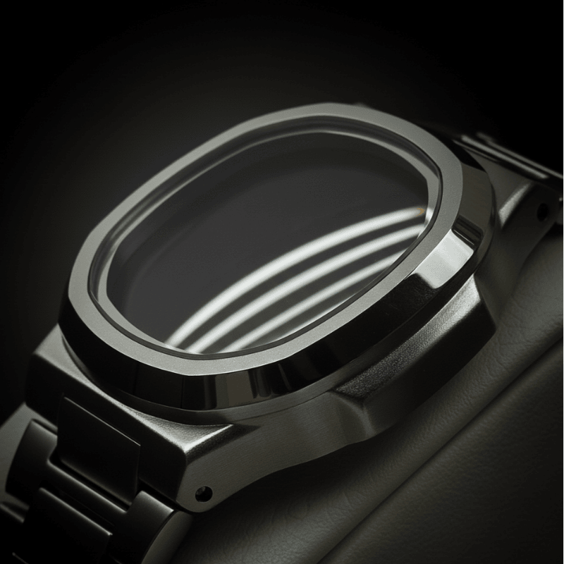 Close-up of a metallic watch case with a dark background