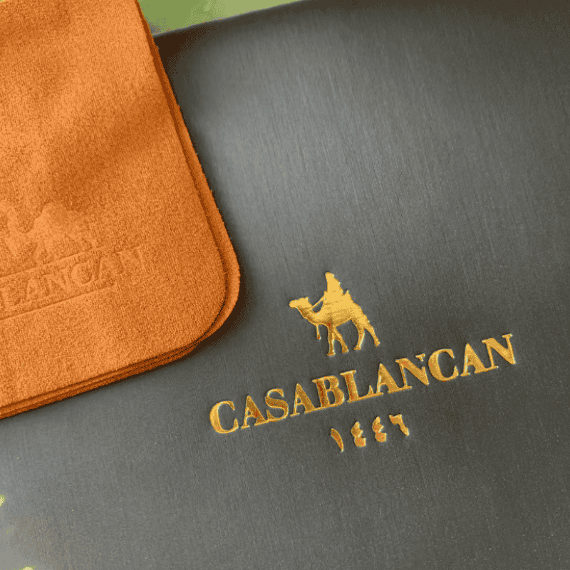 Casablancan brand logo on a Leather watch box with an orange leather product.