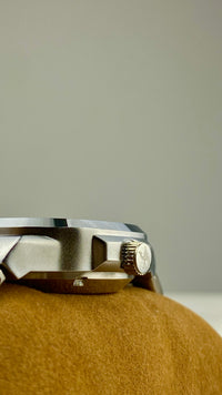 Close-up of Casablancan arabic numeral automatic watch back view on a textured surface with a neutral background