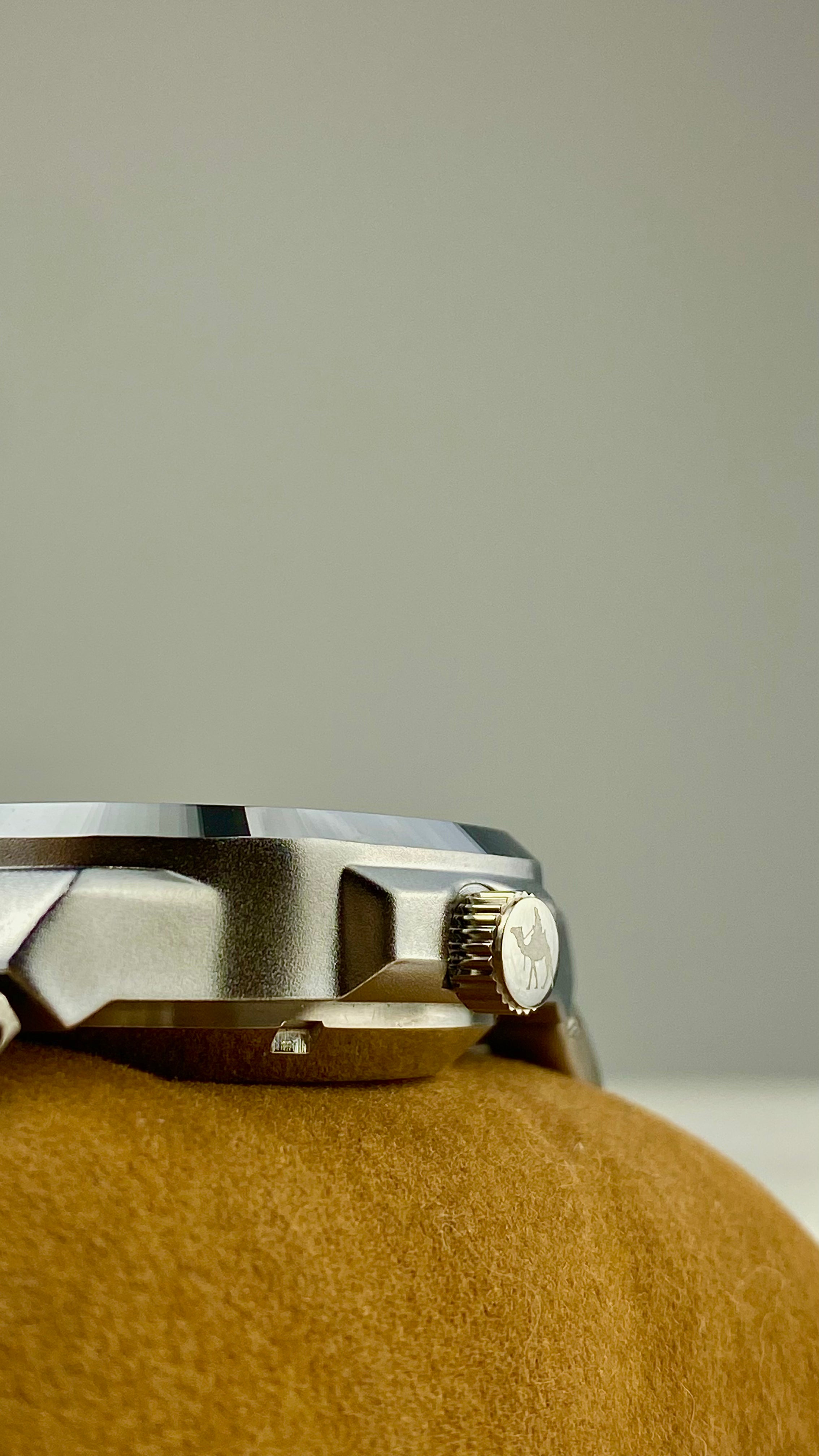 Close-up of Casablancan arabic numeral automatic watch back view on a textured surface with a neutral background